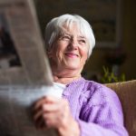 cappella grand junction senior woman reading newspaper