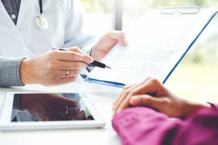 cappella of grand junction doctor with chart advising patient