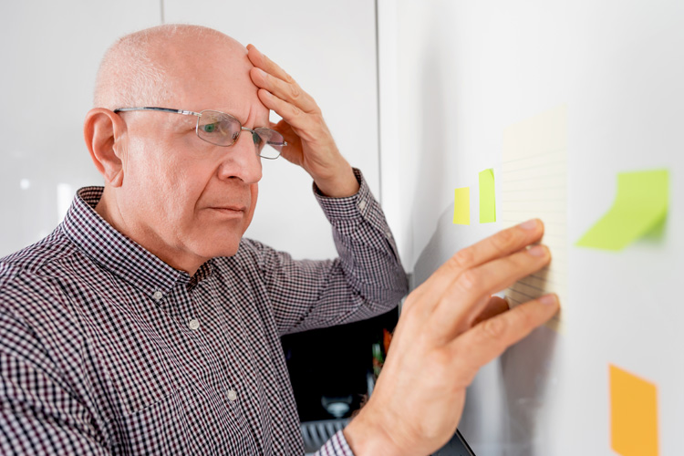 cappella of grand junction senior man confused looking at post it notes