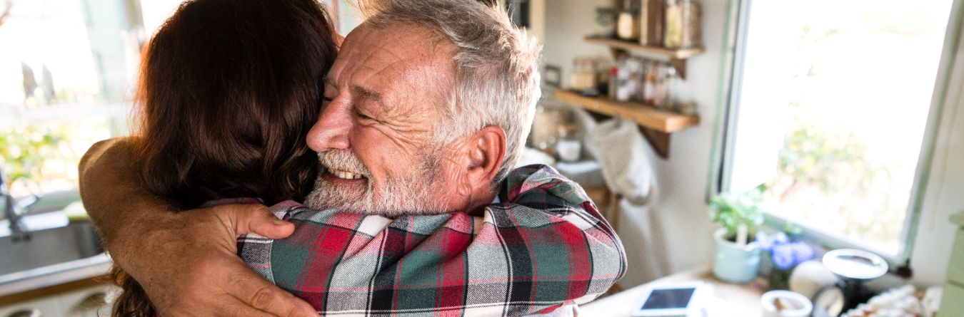 father and daughter hugging holiday tips for caregivers