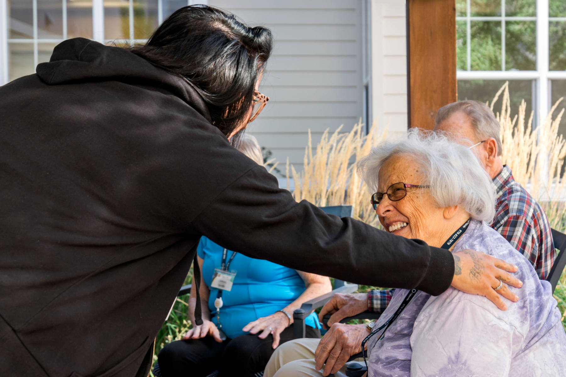 residents and care partner enjoying the fall outside on the pergola 10 landscape