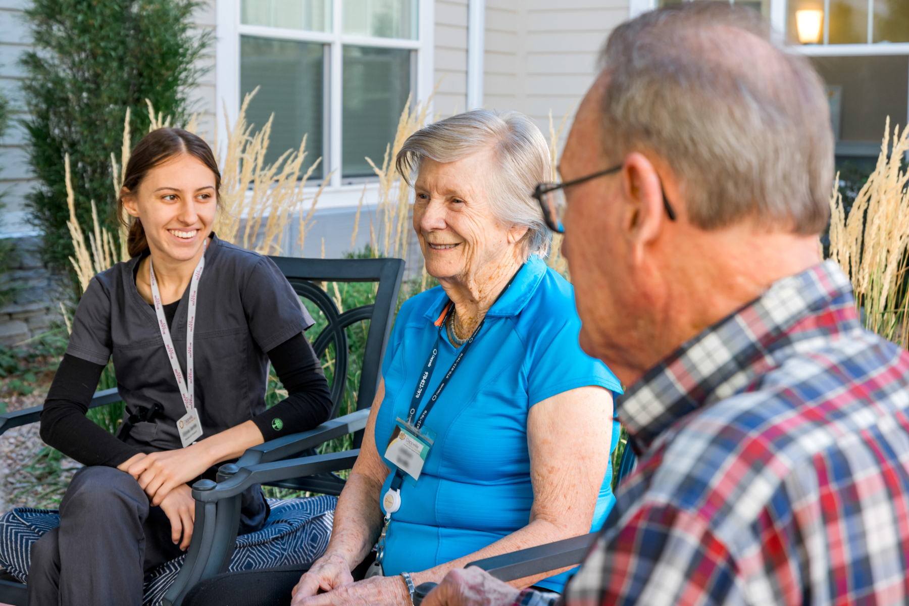 residents and care partner enjoying the fall outside on the pergola 4 landscape