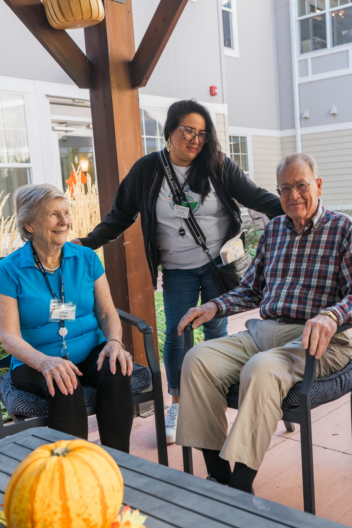 residents sitting on the patio with care partner portrait