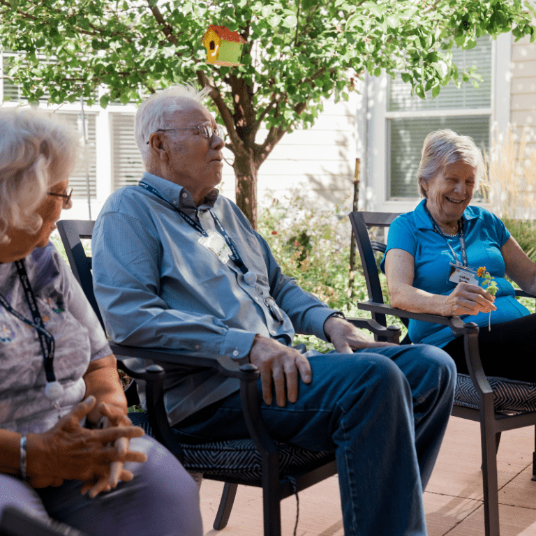 residents sitting outside under the shade 3 square