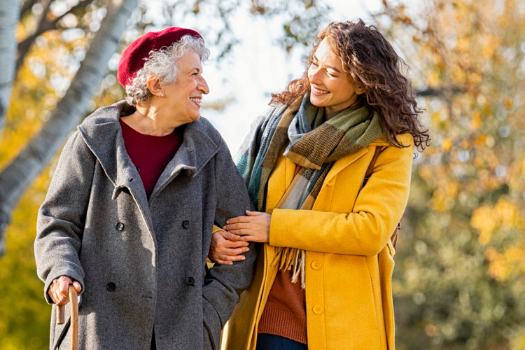senior woman and daughter walking