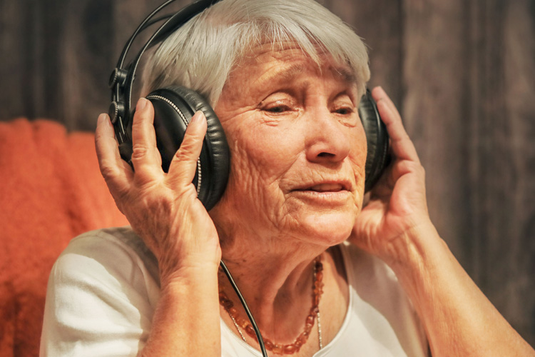 cappella of grand junction senior woman listening to music with headphones