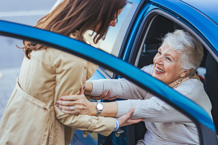 cappella of grand junction young woman helping senior woman out of car