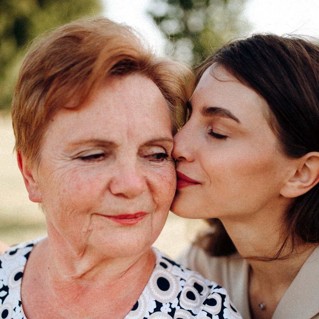 cappella grand junction senior woman kissed on cheek by adult daughter