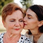 cappella grand junction senior woman kissed on cheek by adult daughter